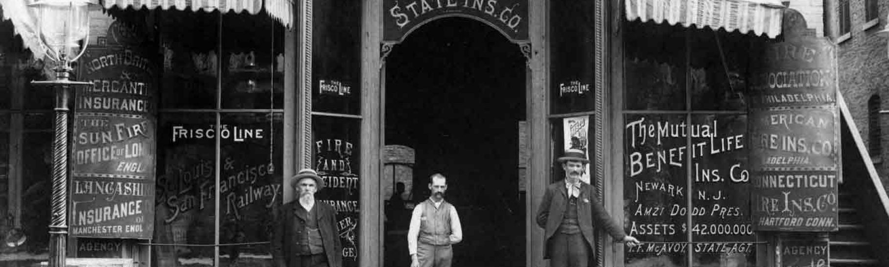 Exterior of J.W. Witmer & Company Insurance with personnel posing in front. Insurance has been a major industry In Iowa since the early 1800s. Des Moines, Iowa. ca.1885.