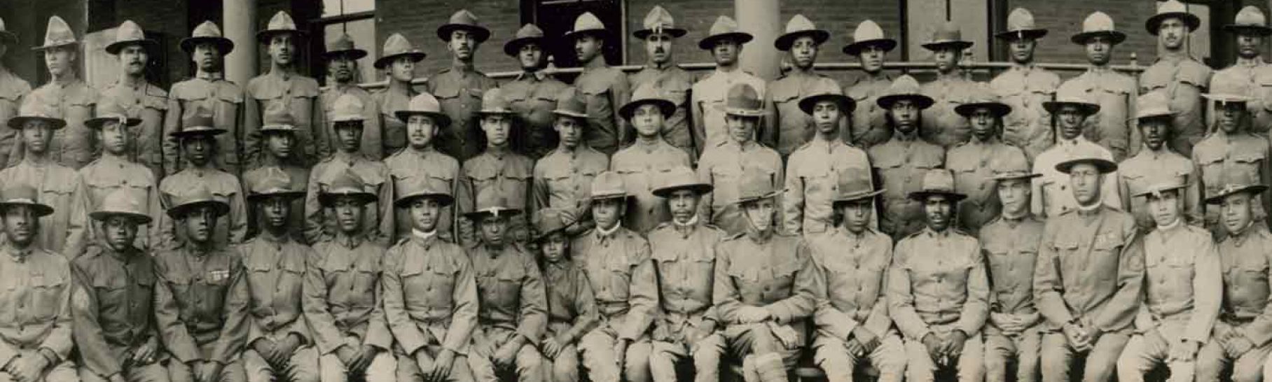 Group portrait of African American officers standing in front of a building at the Fort Des Moines Provisional Army Officer Training School in Des Moines, Iowa, in 1917