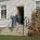 Image of students leaving a one-room school house at the end of the school day