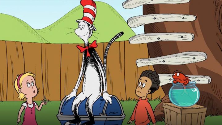The Cat in the Hat sits on a treasure chest while two children and a fish look on.