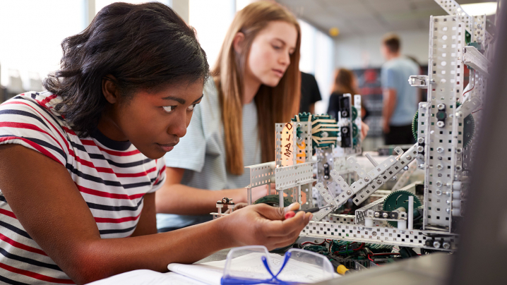 Young girl working on a robotics project.