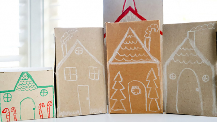 Brown boxes turned upside down and drawn on to resemble a gingerbread village.