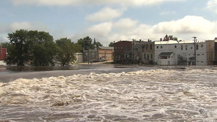 Rapidly moving flood waters encroaching on businesses in a small Iowa town.