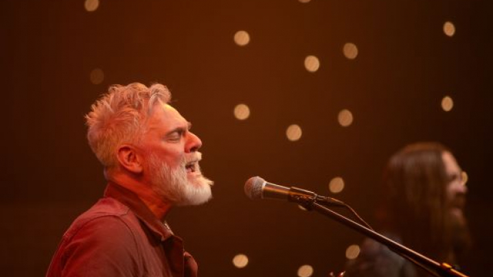The singer Dickie singing into a microphone
