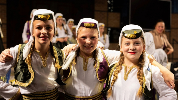Balkan folk dancers posing before a performance