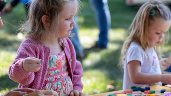 Two little girls playing with STEAM interactive activities at a table