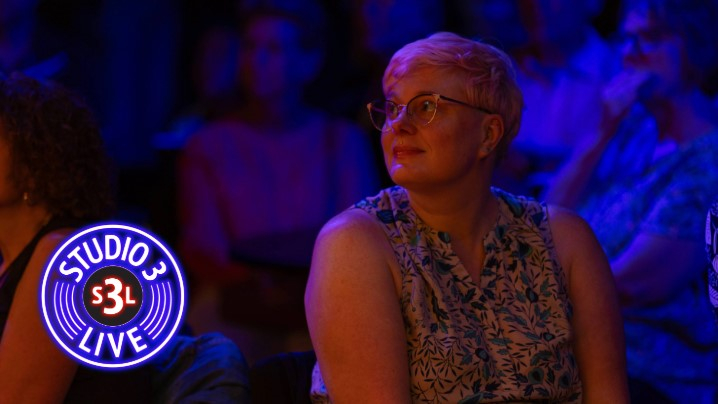 A woman watching a band perform.