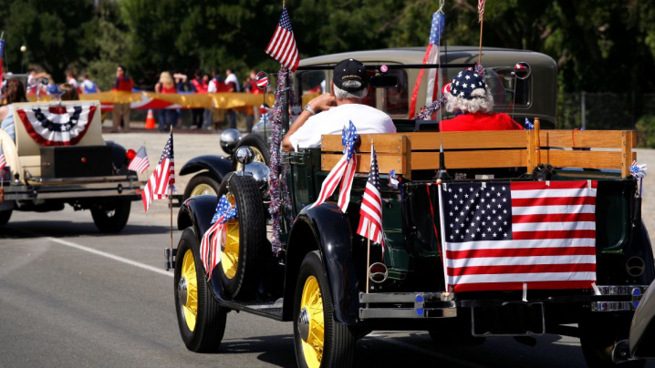 antique car with American flag in parade