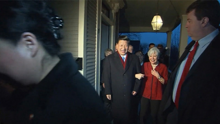 China’s President Xi Jinping and Sarah Lande, Iowa Sister States Organization, walk arm in arm across the front porch of her home in Muscatine, Iowa.