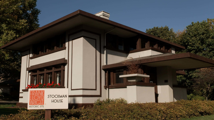 A house designed with horizontal lines, a flat roof with broad overhanging eaves.