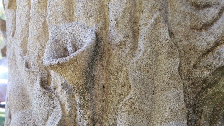 A marble stone carved to resemble a tree trunk.
