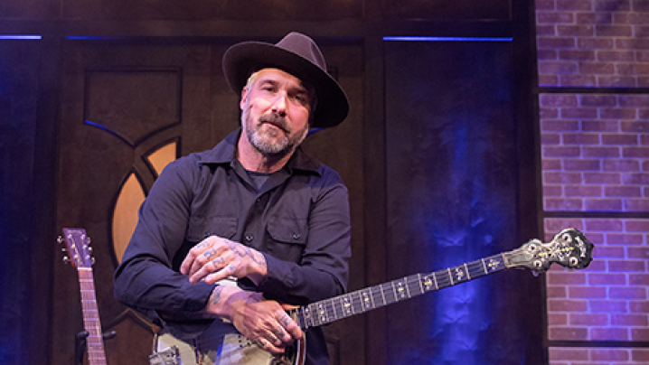 William Elliott Whitmore holding a banjo on the set of Studio 3 LIVE.