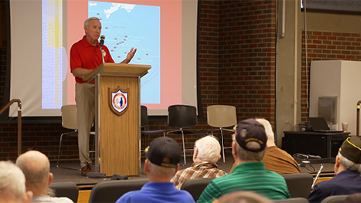 Retired Colonel Gerry Berry gives a presentation to veterans at the Iowa Veterans Home.