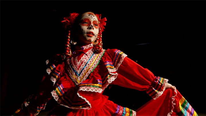 A female dancer from Cedar Rapids-based ballet folklorico troupe Fuerzas Culturales performs in a red dress.
