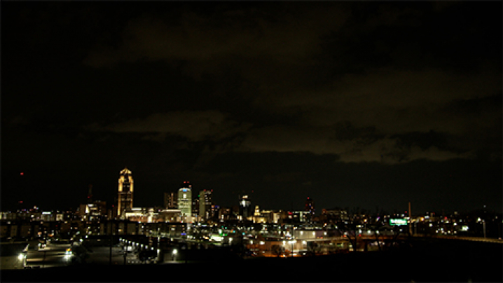 The Des Moines skyline at night. Light from the city reflects off of the clouds.