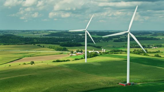 Wind turbines across an agricultural landscape