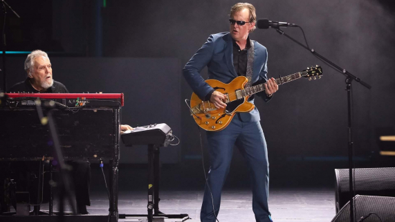 Joe Bonamassa playing guitar by piano