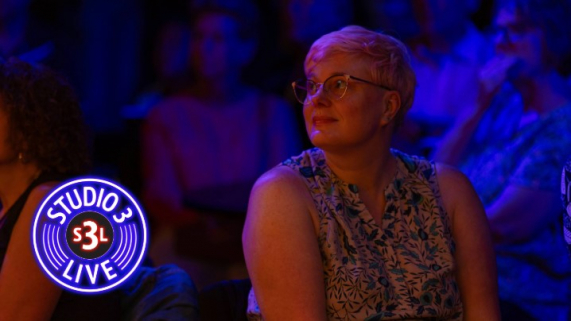 A woman watching a band perform.