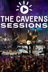 A band is on stage playing and waving to a crowd of people in the subterranean amphitheater of The Caverns in Tennessee's majestic Cumberland Mountains.