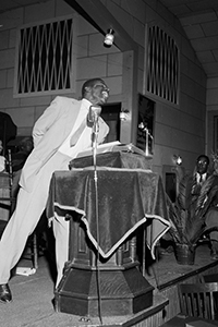 Rev. Fred Shuttlesworth preaching from the pulpit.