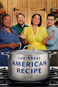 The Great American Recipe title on a large kitchen stove pot. Three personalities from the show smile at the camera behind the pot. Two women and one man.
