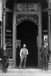 Exterior of J.W. Witmer & Company Insurance with personnel posing in front. Insurance has been a major industry In Iowa since the early 1800s. Des Moines, Iowa. ca.1885.