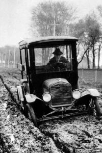 Car stuck in muddy road. ca. 1920.