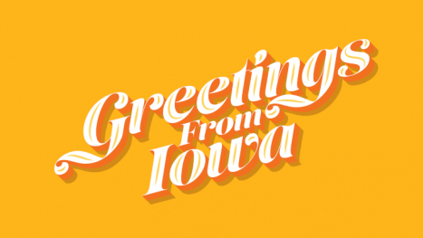 Text on a orange background reads Greetings From Iowa 