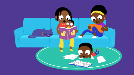 Family reading on couch together