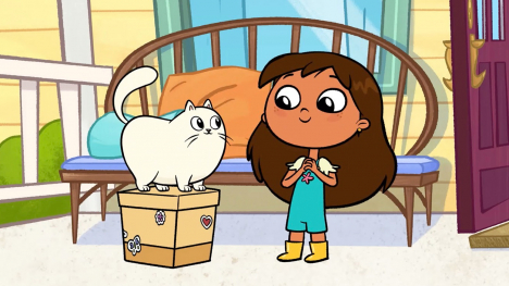 Rosie Fuentes stands next to her pet cat, Gatita. Gatita is standing on a box. They are both on a front porch.