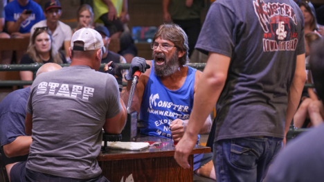 Monster arm wrestling participants in the heat of the battle