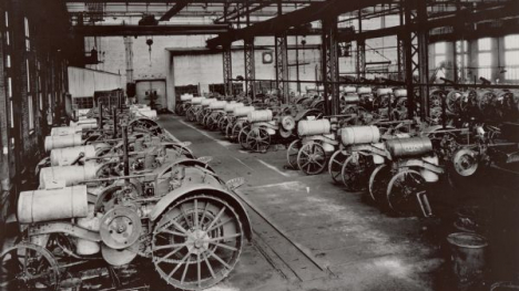 Tractor factory with rows of tractors in the early 20th century