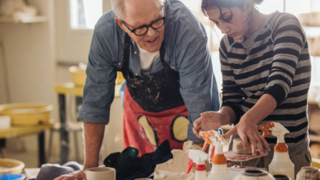John Lithgow and a student named Rosie work on a ceramics project together