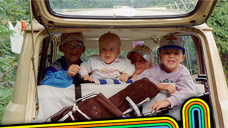Vintage photo of kids traveling in the back of a car