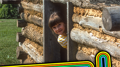 vintage photo of a little girl in a log cabin