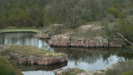 Image of rock outcrops along water.