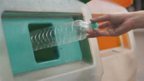 Recycling a plastic water bottle.