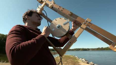 Image of a man with a kite flying mechanism.