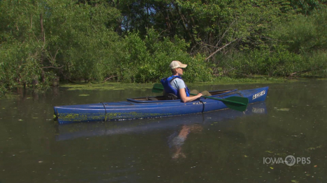 Image of woman in a canoe on a lake.