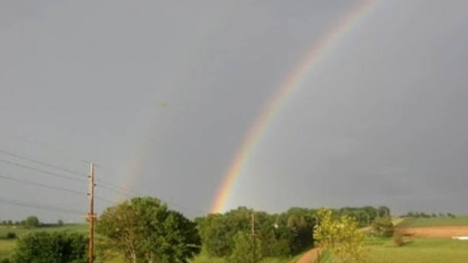 Image of a rainbow over a field.