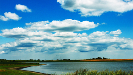 A lake with a muddy shoreline.