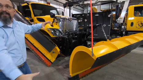 Image of man in front of snow plow.