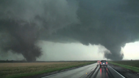 Image of tornadoes along a country road.