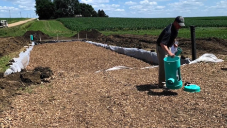 Image of person working on woodchip bioreactor.