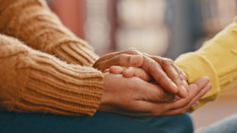 Two people holding hands