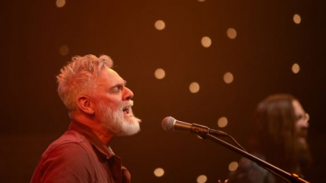 The singer Dickie singing into a microphone