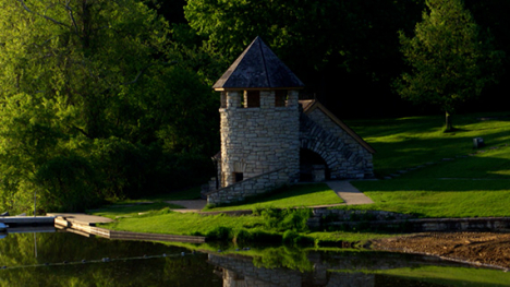 A limestone boathouse shaped like a castle tower.