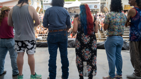 Row of mullet contest participants on stage