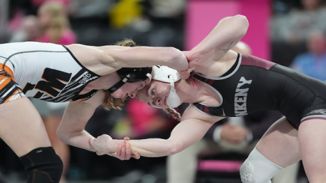 two girls wrestling. They are holding arms 