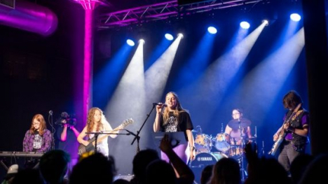 A group of young people on a stage performing